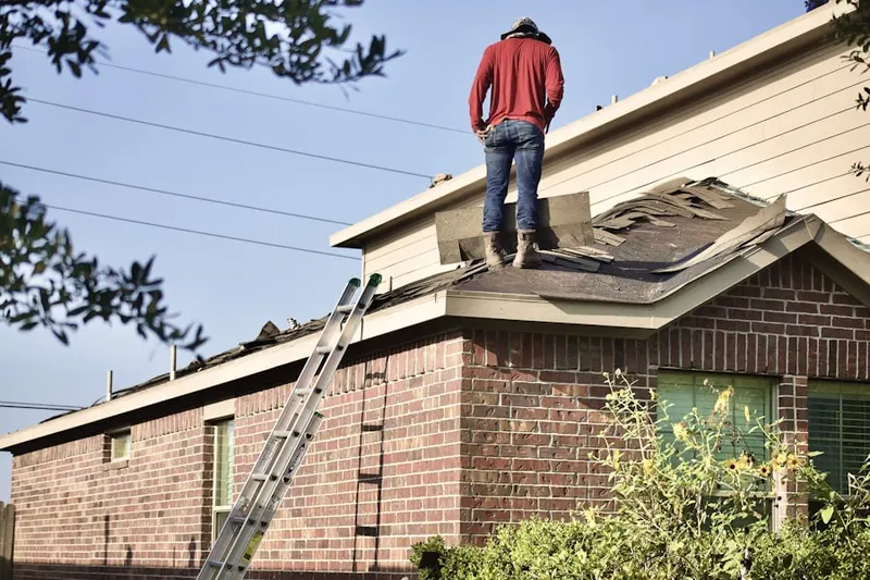 Professional roofer working on a residential roof in Big Bay